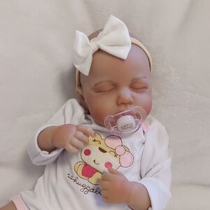Adorable Baby Doll with White Bow and Pacifier